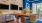a kitchen with a stone wall full of tvs