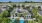 a large clubhouse with a pool and trees around it