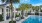 a pool with chairs and palm trees