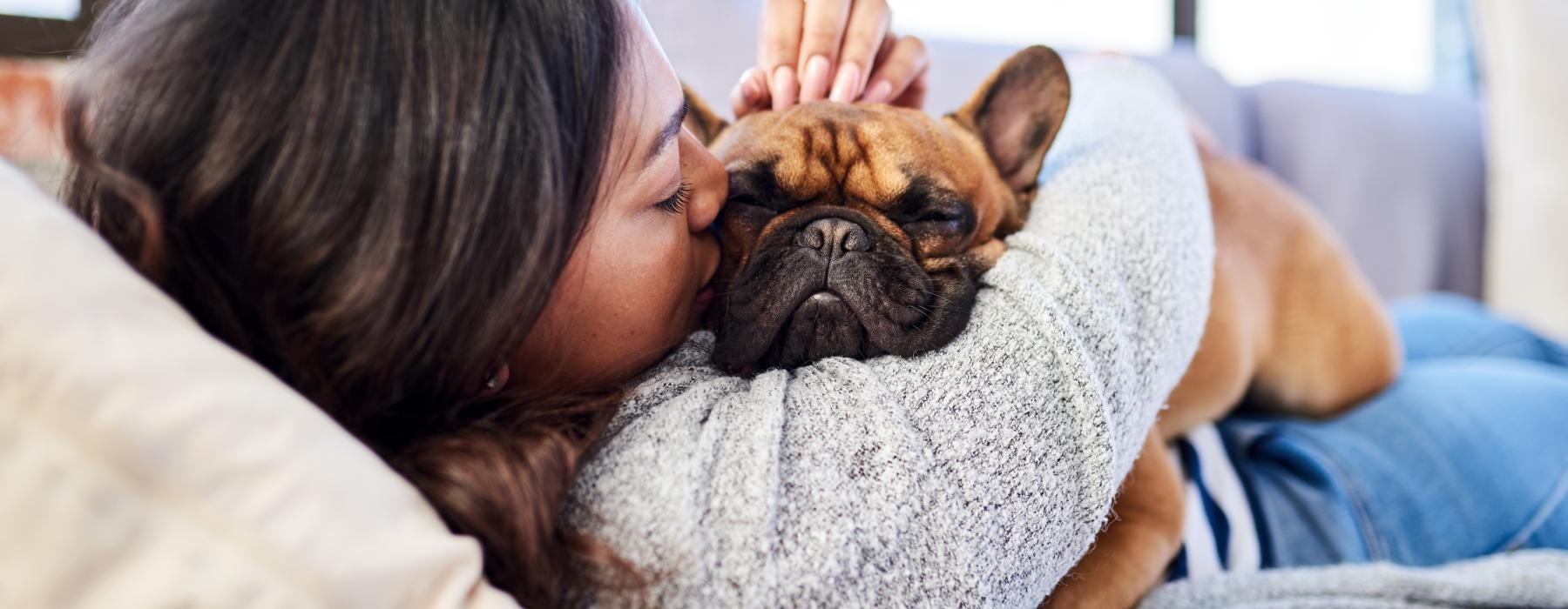 a person sleeping with a dog