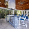 covered outdoor lounge with seating and kitchen