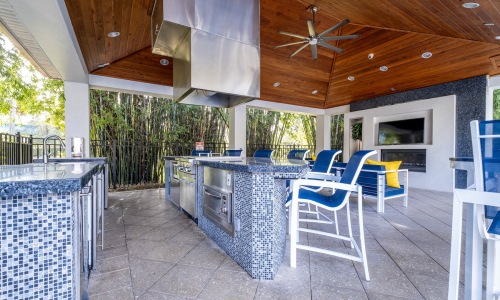 covered outdoor lounge with seating and kitchen
