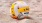 a yellow and white volleyball on a beach