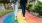 a pair of people walking on a colorful path