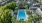a pool surrounded by trees and buildings